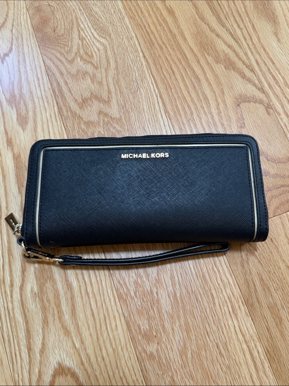 Michael kors black with gold saffiano jet set continental wallet/wristlet.